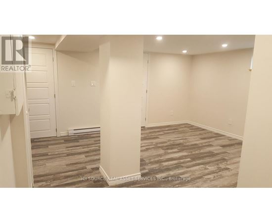 A room with a wooden floor and white walls.