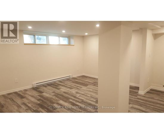 A room with a carpeted floor and a window.