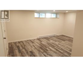 A room with a wooden floor and a window.