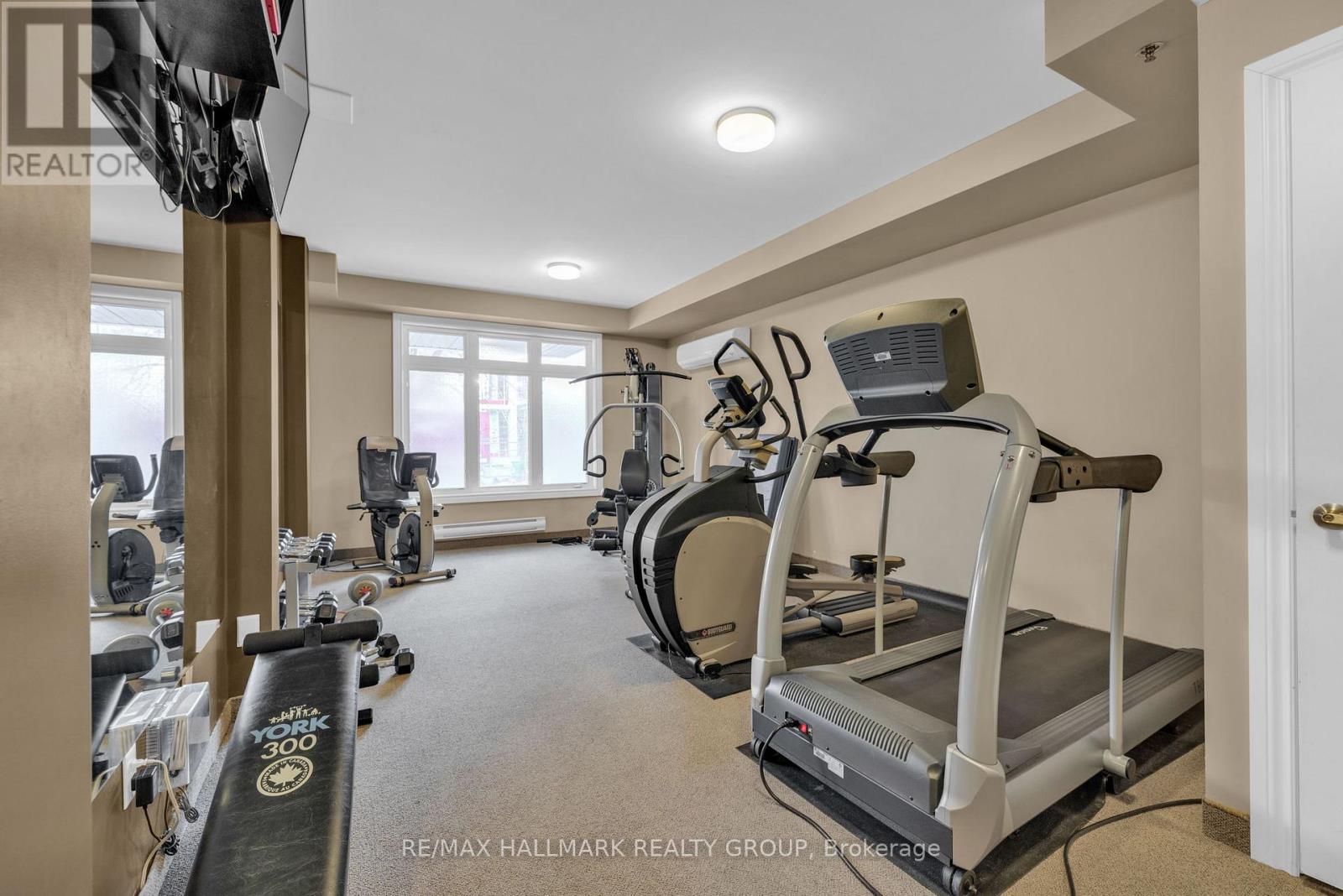 A well-equipped home gym with treadmills, elliptical machines, and other exercise equipment.