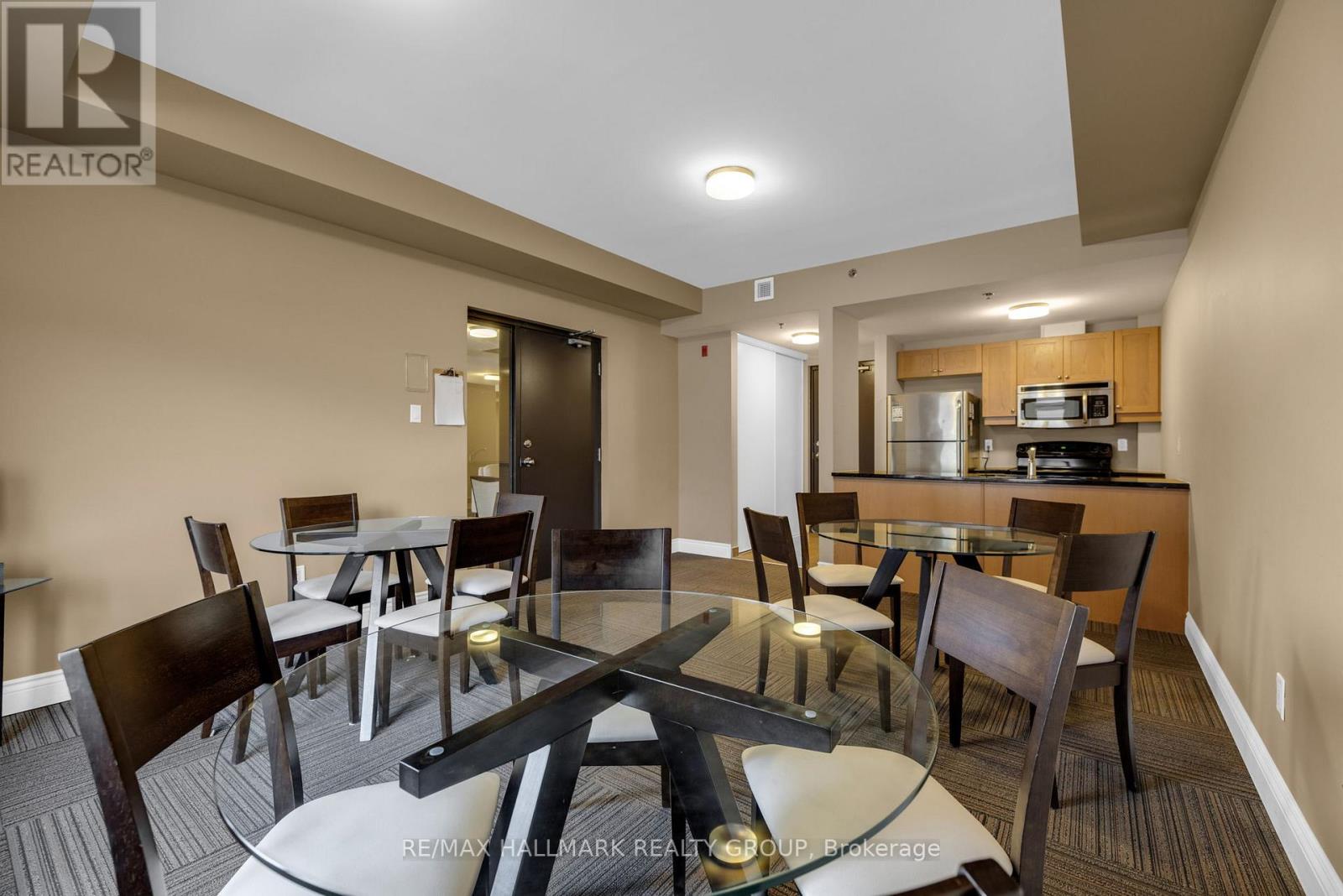 A modern dining room with a glass table and chairs.