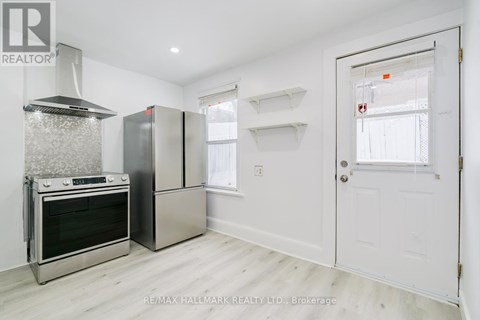 A kitchen with a stainless steel oven and refrigerator.