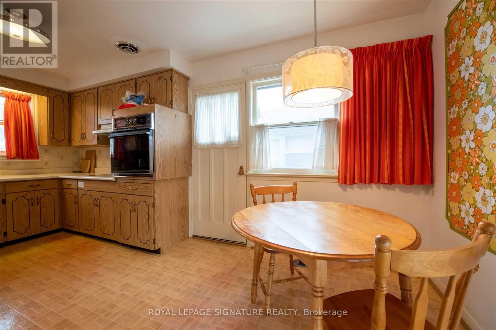 A kitchen with wooden cabinets and a table.