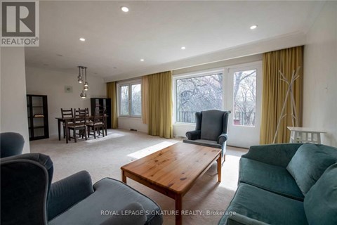A living room with a wooden table and grey couches.