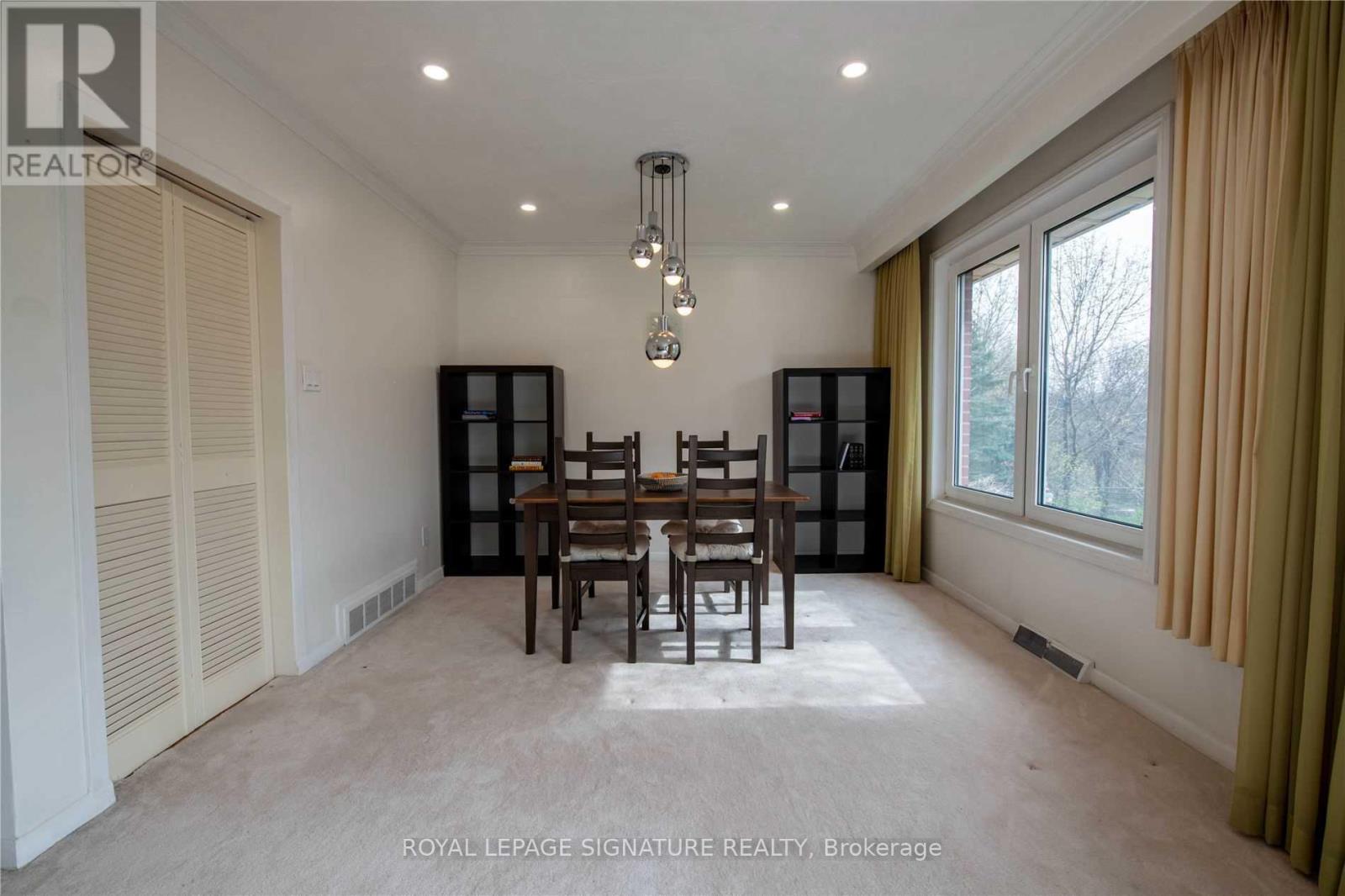 A dining room with a table set for four.