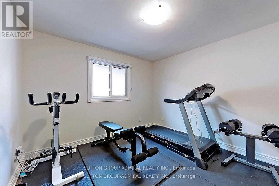 A home gym with a treadmill, exercise bike, and weights.