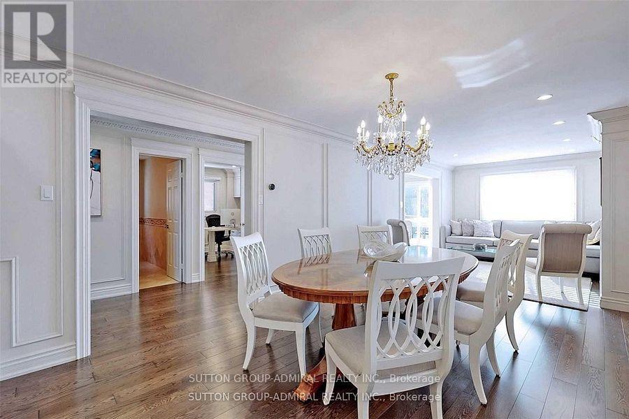 A dining room with a wooden table and chairs.