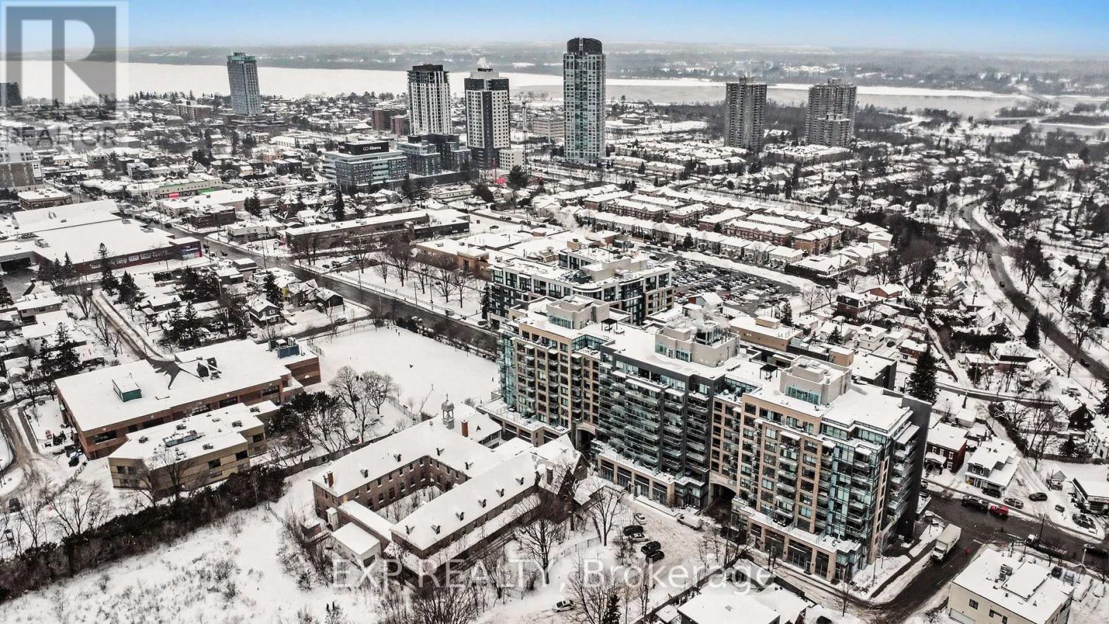 A cityscape with buildings and roads covered in snow.