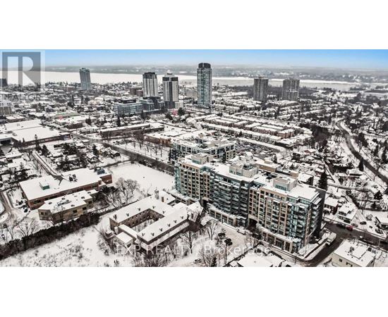 A cityscape with buildings and roads covered in snow.