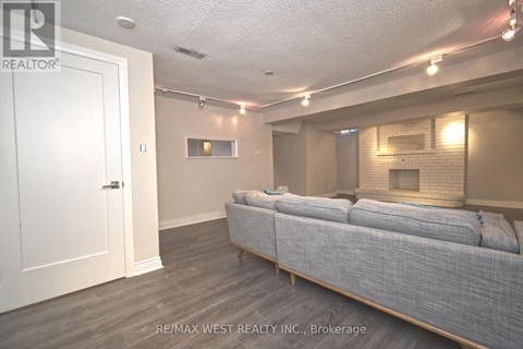 A living room with a grey couch and a white door.