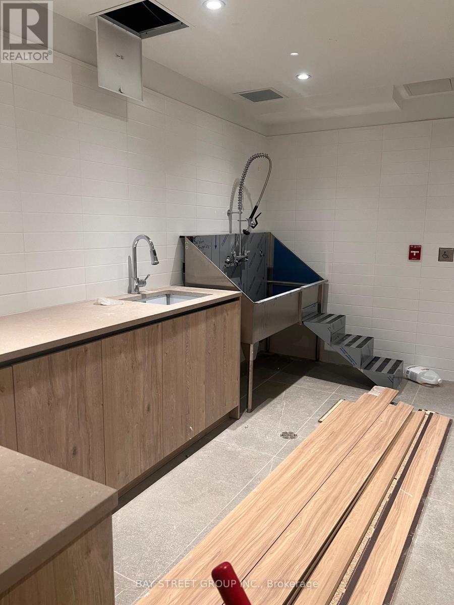A bathroom with a sink and a shower stall.