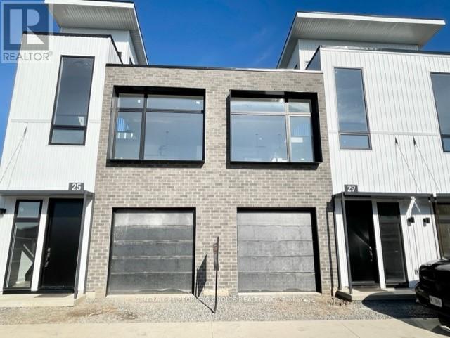 A modern two-story house with a flat roof and a garage door.