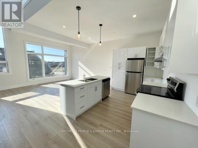 A modern kitchen with white cabinets and a large island.