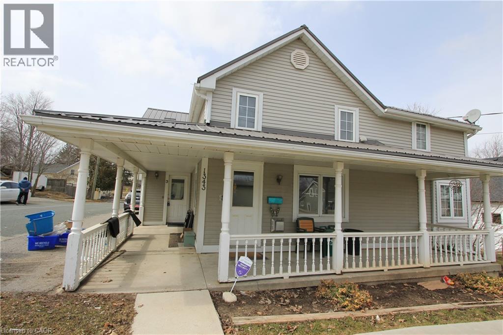 A house with a porch and a sign that says REALTOR.