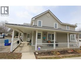 A house with a porch and a sign that says REALTOR.