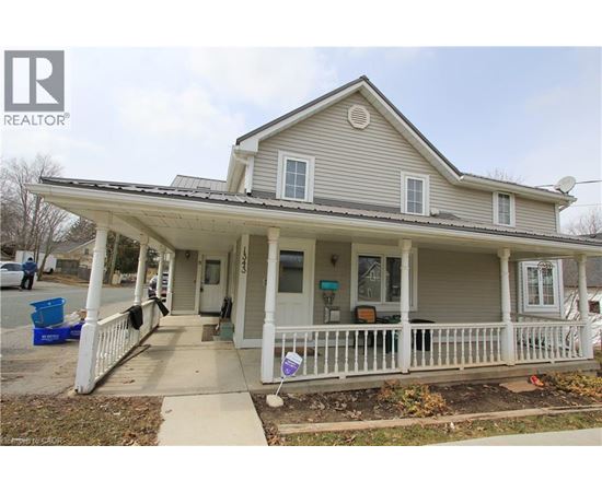 A house with a porch and a sign that says REALTOR.