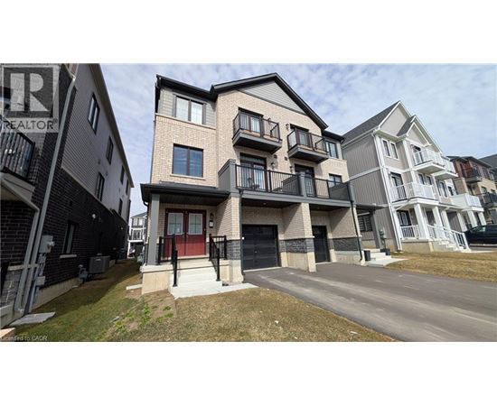 A row of modern townhouses with balconies and garages.