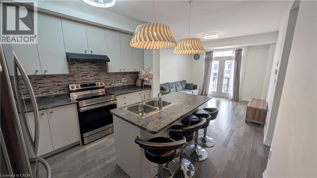 A modern kitchen with a large island and bar stools.