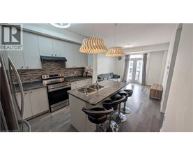 A modern kitchen with a large island and bar stools.