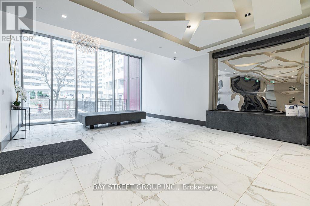 A spacious office with a large window and a view of the city.