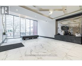 A spacious office with a large window and a view of the city.
