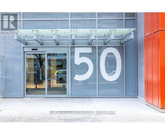 The entrance to a building with a glass door and a number 50 on it.