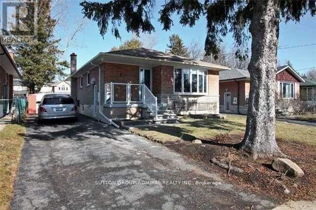 A house with a tree in front of it.