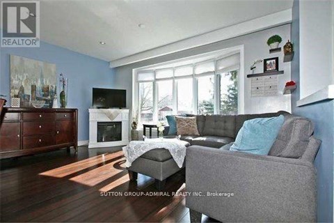 A living room with a grey couch and a television.