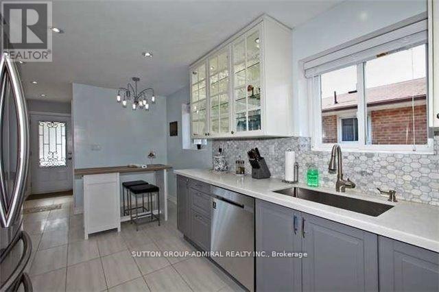 A kitchen with white cabinets and a stainless steel dishwasher.