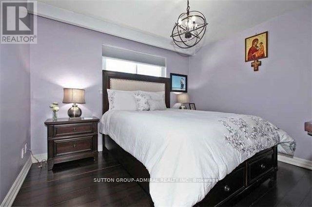 A bedroom with a bed, nightstand, and lamp.