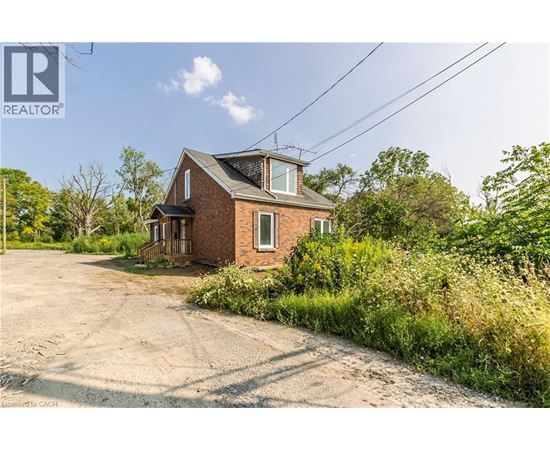 A house with a driveway in front of it is for sale.