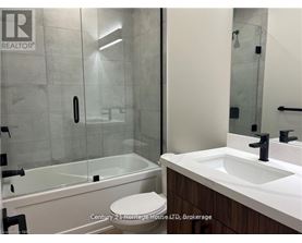 A bathroom with a sink, toilet and shower.