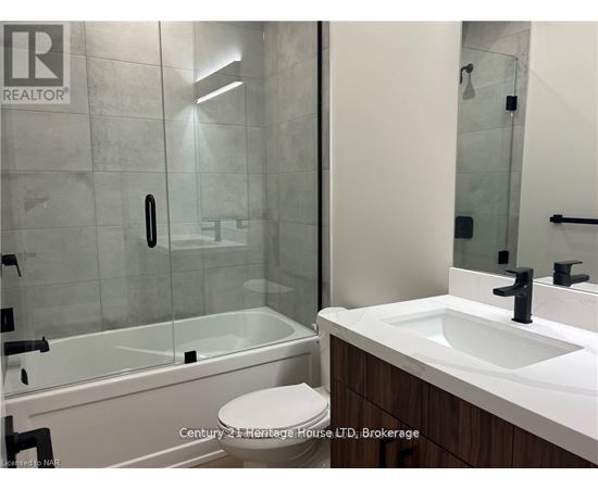 A bathroom with a sink, toilet and shower.