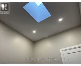 A room with a skylight and a white door.