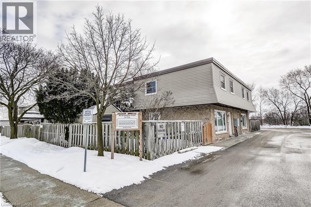 A house with a snow-covered ground and a wooden fence.