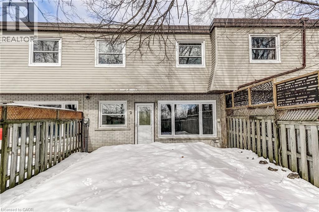 A snow-covered front yard of a residential building.