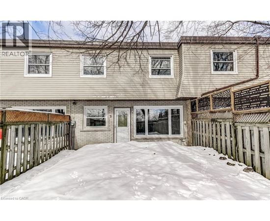 A snow-covered front yard of a residential building.