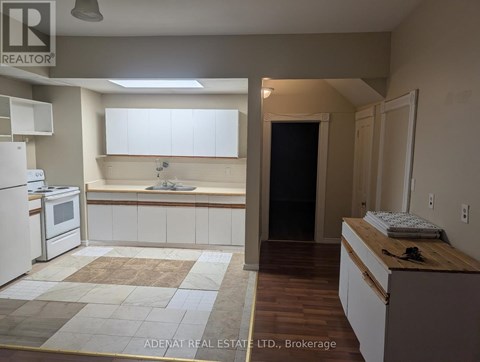 A kitchen with white appliances and a wooden counter.