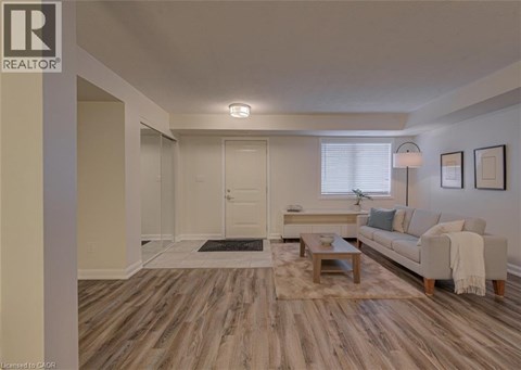 A living room with a couch, coffee table, and pictures on the wall.