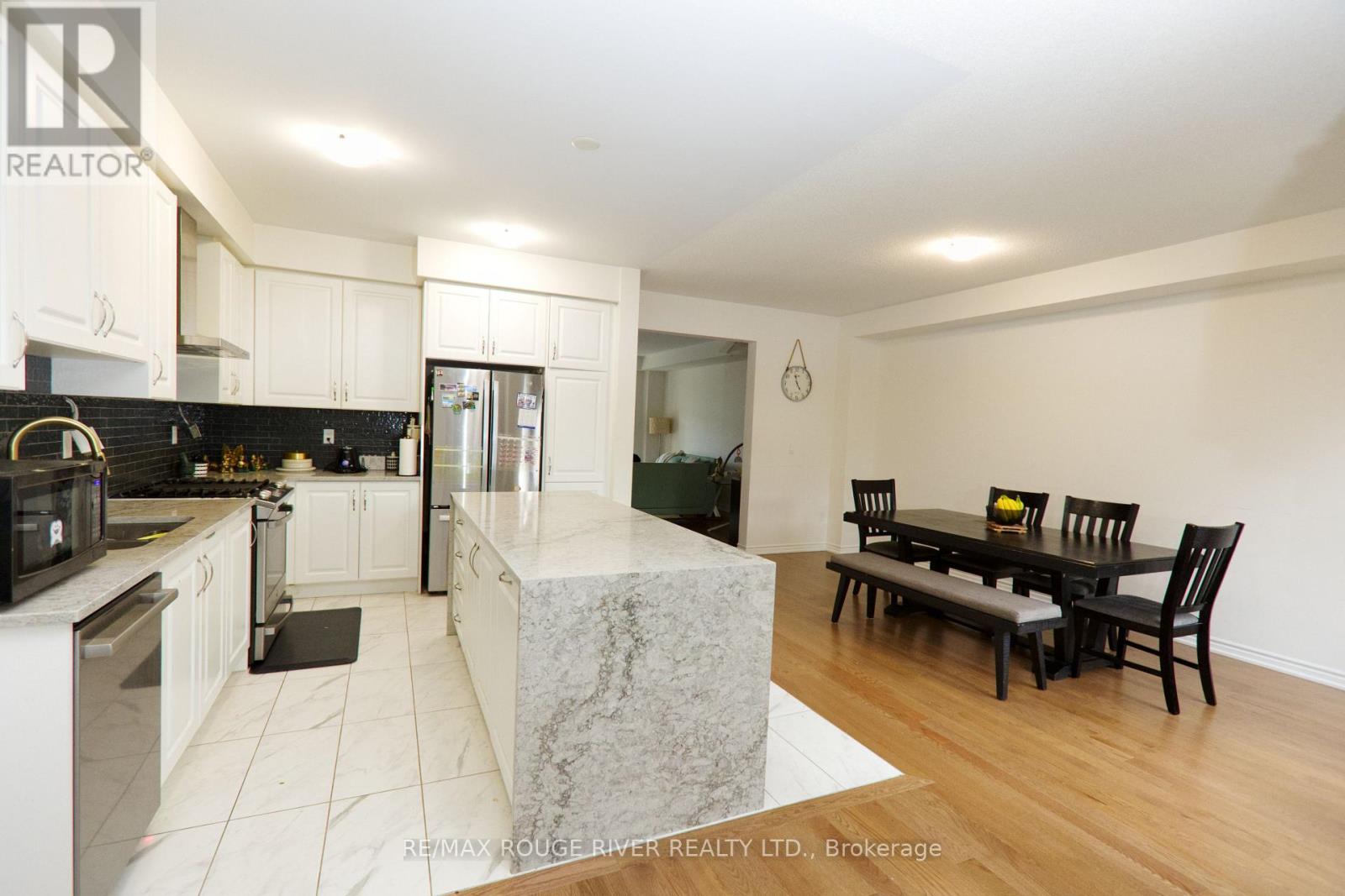 A modern kitchen with a dining table and chairs.
