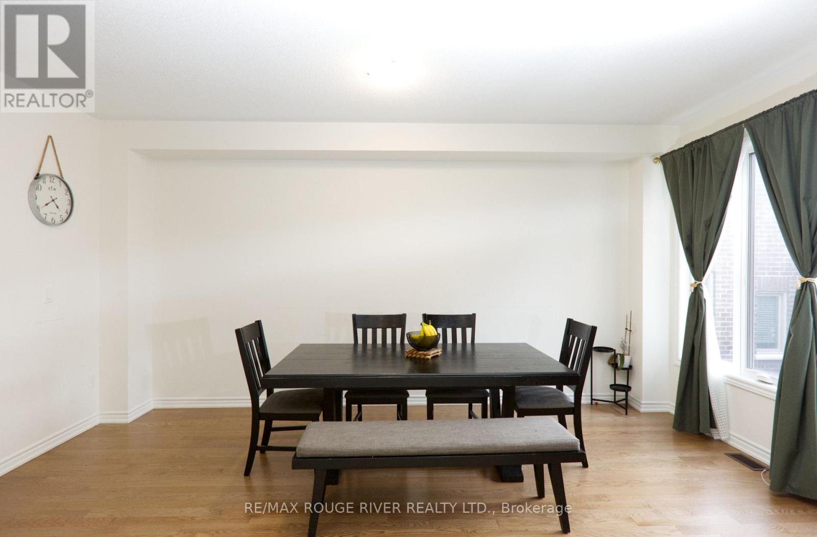 A dining room with a table set for six.