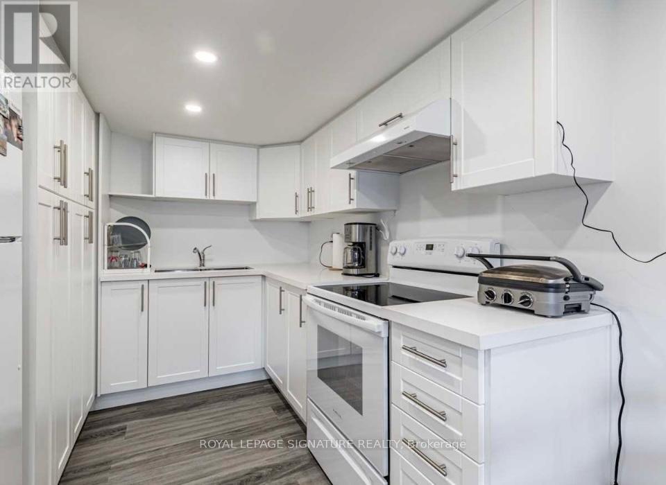A white kitchen with a stove and cabinets.