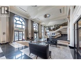 A spacious lobby with a staircase and a large window.