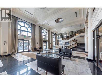 A spacious lobby with a staircase and a large window.