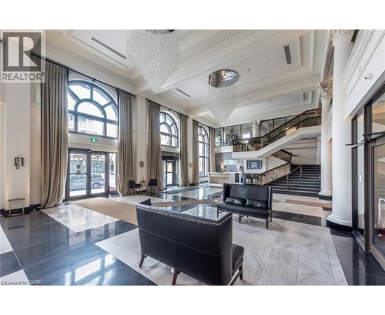 A spacious lobby with a staircase and a large window.
