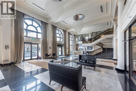 A spacious lobby with a staircase and a large window.