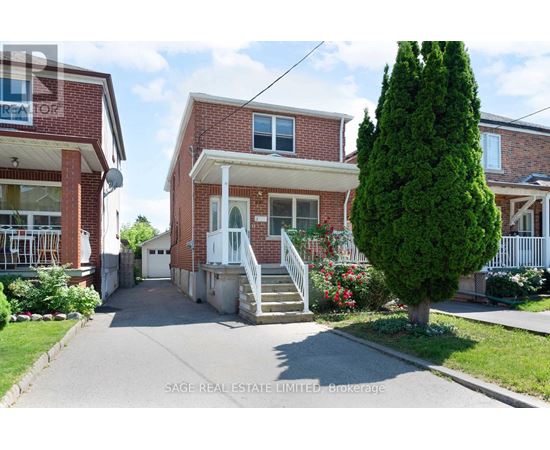 A red brick house with a white door and windows.