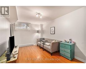 A living room with a couch, television, and a dresser.