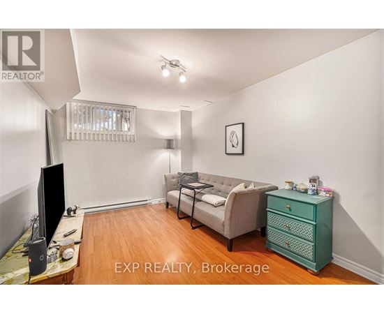 A living room with a couch, television, and a dresser.