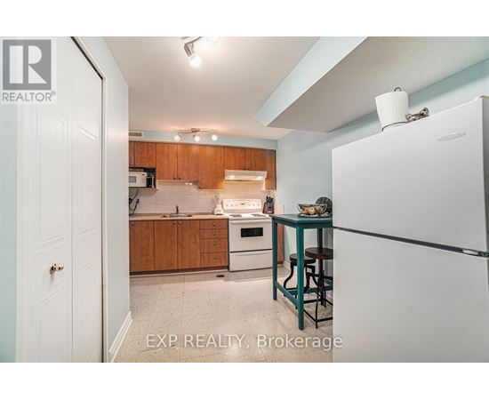 A kitchen with wooden cabinets and a white refrigerator.